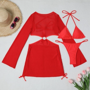Detailed flat lay of a red three-piece bikini set with hollowed-out mesh cover-up and ring