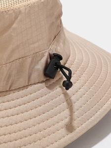 Detail of khaki outdoor sun hat featuring breathable mesh and adjustable drawstring toggle