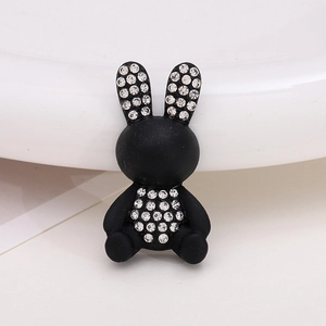 Detail of matte black cartoon rabbit shoe charm with sparkling clear rhinestones inlay