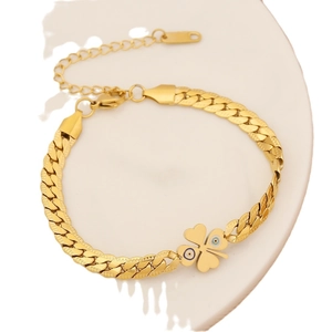 Gold stainless steel bracelet with clover and evil eye charms on a minimal flat chain