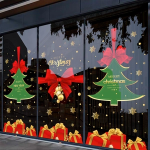 Christmas window stickers with gold Merry Christmas text, green tree, and red gift boxes