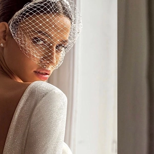 Detail of white bridal birdcage veil with sparkling rhinestones and mesh texture