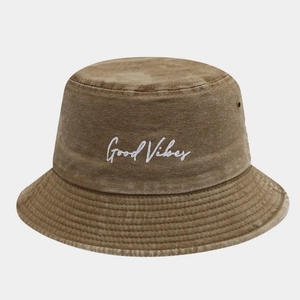 Detail of embroidered Good Vibes text on vintage washed cotton bucket hat with eyelets