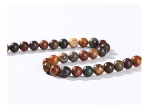 Macro detail of natural stone round beads in earthy tones for DIY jewelry making