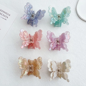 Detailed set of six iridescent resin butterfly hair claws in various vibrant colors