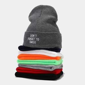 Winter rib-knit beanies stacked in multiple colors featuring slogan embroidery