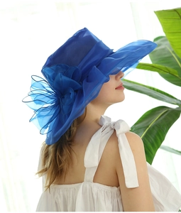 Detail of elegant navy blue organza sun hat with layered 3D floral decoration