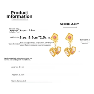 Detailed view of vintage gold heart drop earrings with dimensions 5.5cm and pink rhinestones