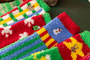 Close-up of thick coral fleece Christmas socks featuring festive holiday patterns