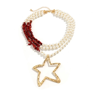 Macro shot of bohemian triple-layer necklace with pearl beads and gold star pendant