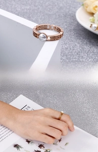 Detail of rose gold geometric hollow ring with pearl and on-hand model display