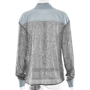 Detail view showing silver sequins and blue striped fabric on long-sleeved shirt back