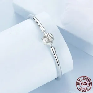 Minimalist S925 sterling silver open bangle with a detailed shell motif in sea style