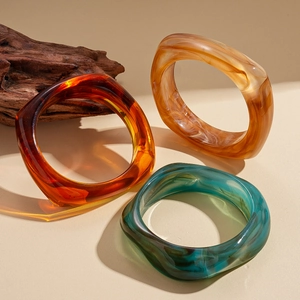 Three-piece set of vintage acrylic geometric bangles in burgundy, amber and cyan resin