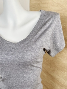 Detail of the V-neckline and mélange knit texture on a gray Tencel wool blend T-shirt
