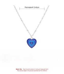 Detail view of heart pendant featuring blue gradient enamel layers and alloy chain