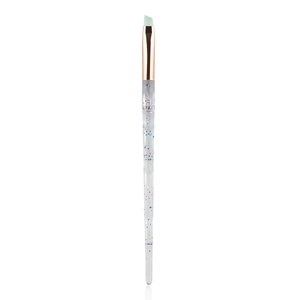 Angled eyebrow brush with mint green bristles and clear glitter crystal handle
