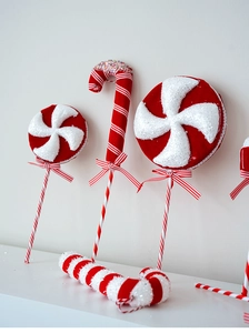 Detail of red and white glittery foam candy cane and lollipop Christmas tree ornaments