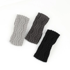 Detailed knit texture of thick winter headbands in black, dark grey, and light grey colors