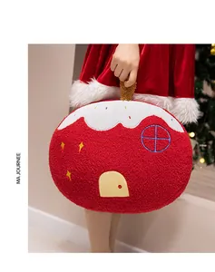 Detail of red plush house pillow with soft textured fabric and festive embroidery