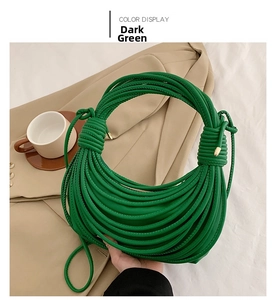 Detail of dark green knotted hobo bag featuring unique tubular leather cord construction