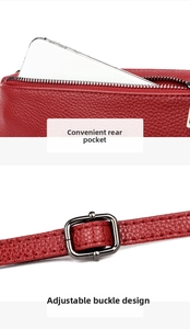 Detail of red pebbled leather bag with back zipper pocket and adjustable strap buckle