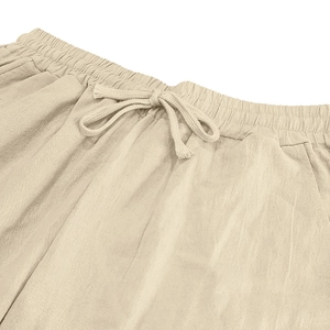 Detailed close-up of drawstring elastic waistband on beige linen blend casual beach shorts