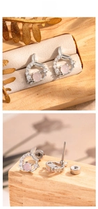 Detail of fishtail stud earrings with pink gemstone and zircon in silver finish