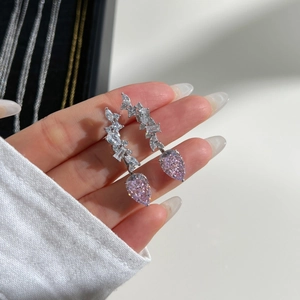 Close-up of S925 sterling silver drop earrings with pink pear-cut stones and zircons