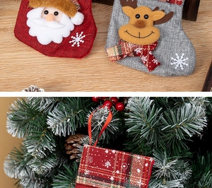 Detail of Santa and reindeer Christmas stockings as tree hanging ornaments and gift bags