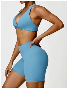 Detail of light blue two-piece yoga set with twist front bra and high waist shorts