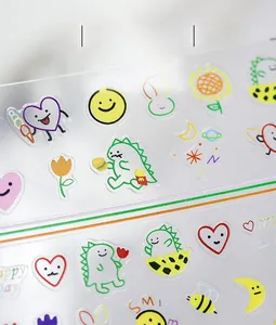 Detail of cartoon nail stickers featuring dinosaur and heart patterns with fine textures