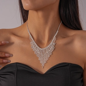 Close-up of elegant silver V-shaped fringe necklace with shimmering rhinestones