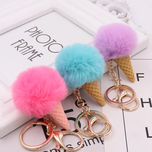 Three colorful plush ice cream cone keychains in pink, blue, and purple with gold clips