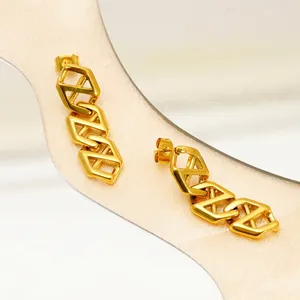 Polished gold geometric chain stud earrings with hollow hexagonal links on silk fabric
