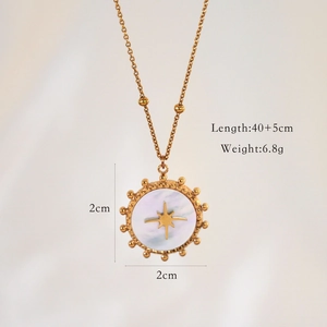 Detail view of 14K gold-plated starburst pendant with white shell and 40+5cm beaded chain