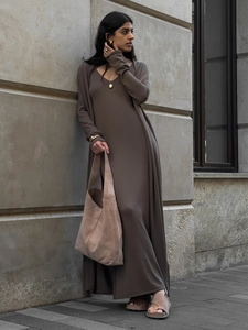 Detail of soft knit long sleeve cardigan and matching brown dress with suede tote bag