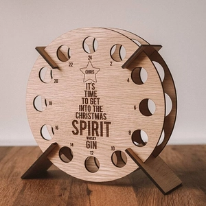 Macro detail of wooden Christmas Ferris wheel countdown calendar and mini bottle holder