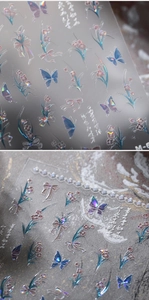 Macro detail of laser holographic nail stickers featuring butterflies and floral patterns