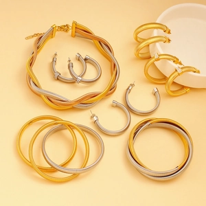 Golden and silver woven chain necklace with C-shaped hoop earrings and bangles set