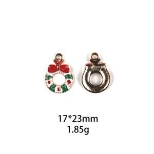 Detail view of 17x23mm Christmas wreath pendant with red and green enamel coating