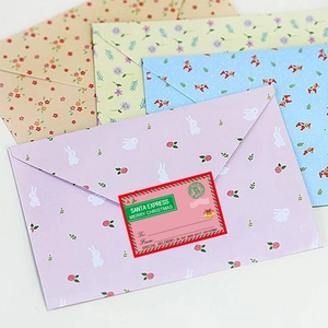 Detailed view of colorful floral envelopes with Santa Express Christmas gift labels