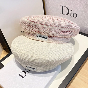 Chic women's beret hats in tweed pink and beige knit with stylish fabric patch