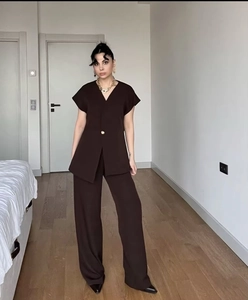 Detail of dark brown two-piece set with V-neck single-button top and wide-leg trousers