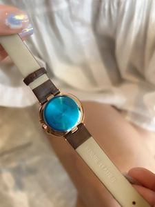 Detail of genuine leather brown strap and rose gold stainless steel watch back case