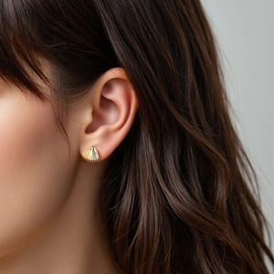 Elegant gold fan-shaped shell stud earrings in S925 sterling silver worn by a model