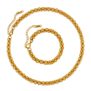 Macro detail of gold stainless steel necklace and bracelet set with K18 stamp on clasp