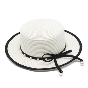 Elegant white straw boater hat featuring pearl ribbon trim and flat top vintage design