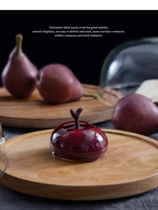 Macro detail of Tasmanian black acacia wood cake tray base with natural grain and stability