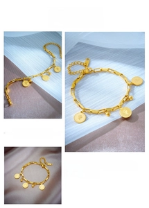Close-up of gold coin bracelet featuring Queen Elizabeth relief and rectangle chain links
